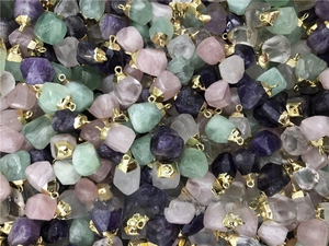 Detailed close-up of colorful natural raw stone pendants with elegant gold metal caps