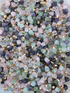 Macro shot of assorted raw natural stones including rose quartz and amethyst with metal clasps