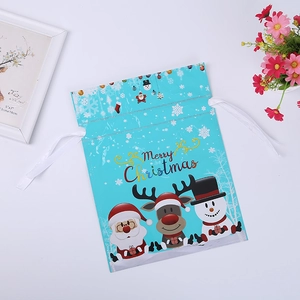 Close-up of sky blue Christmas drawstring gift bag with Santa Claus and reindeer prints