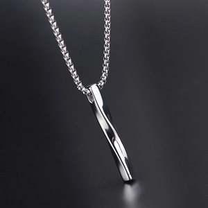 Minimalist twisted bar pendant necklace in silver stainless steel on a dark reflective surface