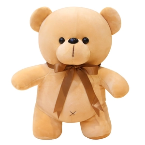 Standing light brown plush teddy bear with dark brown ribbon bow on white background
