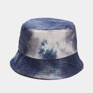 Detailed texture of blue and white tie-dye corduroy fabric on a bucket hat