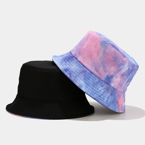 Detail view of tie-dye and black corduroy bucket hats with soft textured fabric