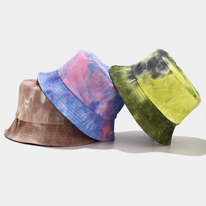 Three tie-dye corduroy bucket hats in brown, blue-pink, and yellow-green color variants