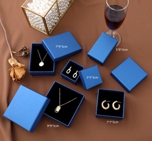 Elegant peacock blue jewelry gift boxes in various sizes shown with silk background