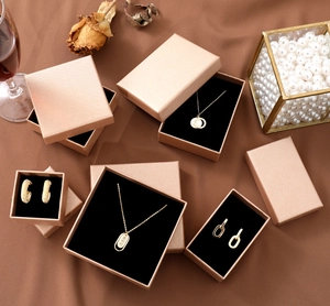 Champagne gold jewelry gift boxes with black flocking lining and matte metallic texture