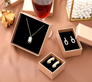 Champagne gold jewelry gift boxes with black velvet lining shown in a luxury setting