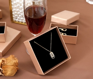 Detail showing elegant champagne gold jewelry gift boxes with matching necklace and decor