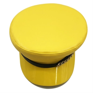 Detail of yellow PU leather newsboy cap with gold metal chain and shiny patent brim