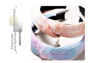 Detail showing cross-knotted striped knit headbands with vibrant gradient color patterns