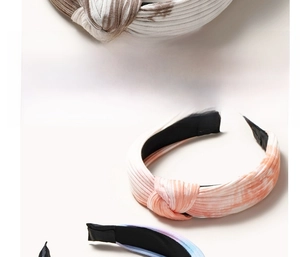 Detail view of colorful tie-dye knotted headbands with vertical stripe textured fabric