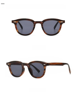 Detail view of narrow retro sunglasses featuring wood grain texture and metal accents
