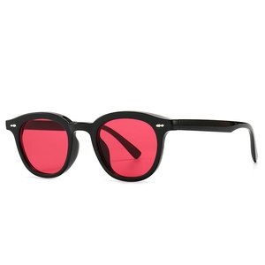 Retro narrow black frame sunglasses with red round lenses and silver rivet details