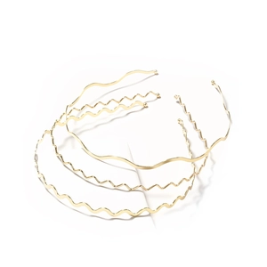Three-piece set of slim gold metal wavy headbands with minimalist polished finish