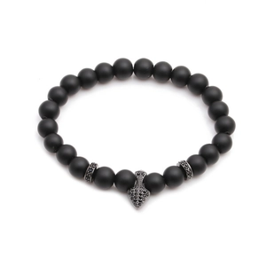 Matte black beaded bracelet set with micro-paved black stone shield charm on white background