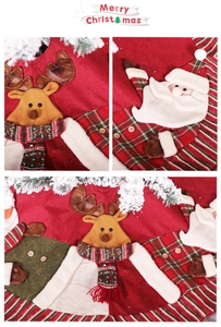 Detail of knitted Christmas tree skirt featuring reindeer and Santa Claus embroidery