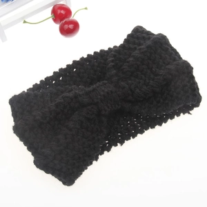 Detail view of black chunky knit ear warmer headband with a central bow design
