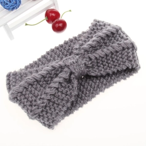 Close-up of dark grey chunky knit headband with twisted knot detail for winter warmth