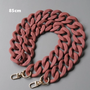 Detail of 85cm matte resin bag chain in dusty rose with golden lobster clasps