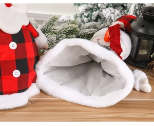 Detail of Santa Claus tree topper featuring red black plaid fabric and white faux fur trim