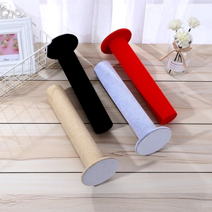 Velvet and linen cylinder T-bar display stands for bracelets and watches on wooden surface