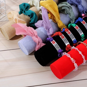 Detail view of velvet jewelry display stand with medical alert bracelets and silk scrunchies