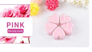 Dettaglio di lumini rosa a forma di cuore al profumo di giglio con decoro floreale