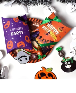 Halloween gift boxes in purple and orange with silk ribbons and decorative paper plates