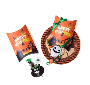 Close-up of orange Halloween gift boxes and paper plates with Happy Halloween lettering