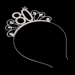 Close-up of number 80 tiara with sparkling rhinestones and pink gemstone detail