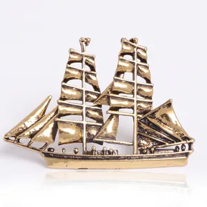 Artistic vintage sailboat brooch with rhinestones and enamel on a white background