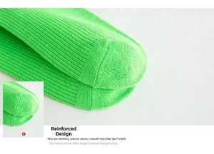 Close-up of bright green cotton crew sock showing reinforced toe and ribbed knit texture