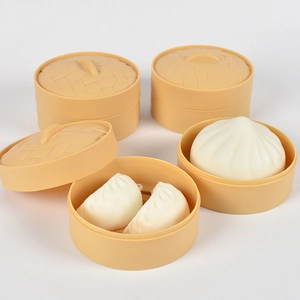 Detailed close-up of mini toy steam baskets with white dumplings and baozi models