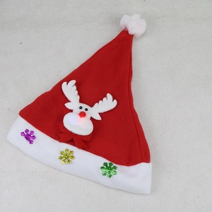 Detail of red glowing Christmas reindeer hat with sequins on the white plush brim
