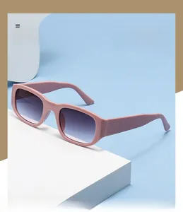 Macro shot of stylish square sunglasses with pink frames and gradient purple lenses