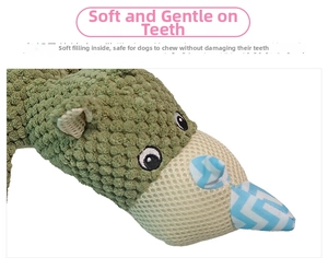Close-up of durable plush dog toy with textured green fabric and soft horn detail