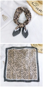 Detail view of leopard print cotton scarf with grey border and stylish knotted display