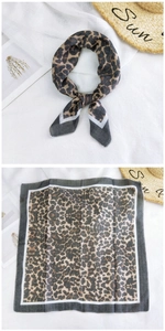 Detail of leopard print cotton linen small square scarf with white border and brown tones