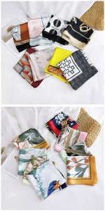 Close-up of vibrant printed square silk scarves with elegant floral and geometric patterns