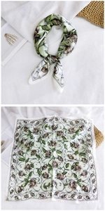 Detailed macro of mint green silk scarf with vintage brown roses and satin finish
