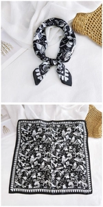 Macro view of silky square scarf featuring vintage black and white floral pattern