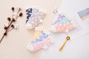 Flat lay of colorful coral fleece heart socks in navy, purple, pink and yellow shades