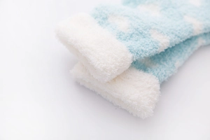 Detail showing plush white fleece cuff on soft blue socks with white cloud pattern