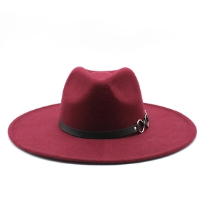 Detail of burgundy wool fedora featuring a black leather band and silver metal ring