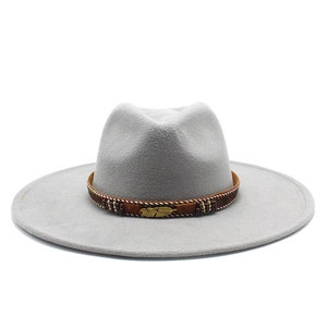 Detail of grey wool felt fedora featuring bohemian woven band and golden feather charm