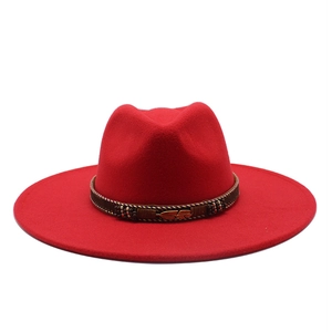 Detail of red fedora hat with brown woven band and gold feather metal buckle