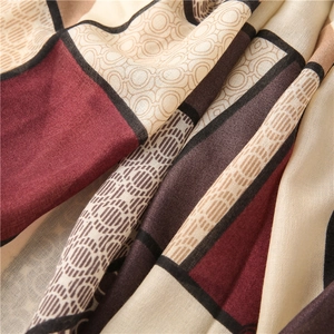 Macro detail of high-quality silk scarf with retro geometric patterns and soft draping