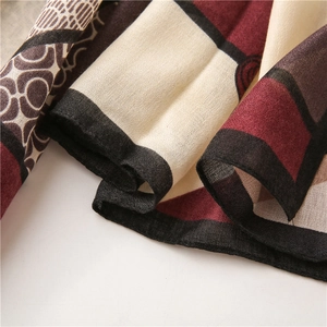 Detail of color-block cotton linen scarf showing geometric patterns and fine stitching