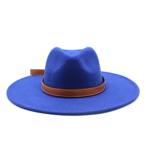 Detail of dark blue felt fedora hat featuring brown leather band with white stitching