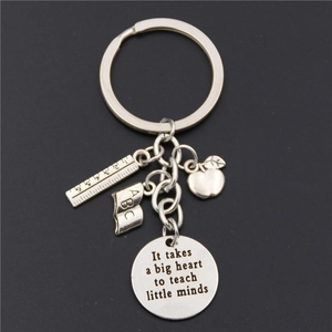 Silver teacher keychain detail with engraved heart quote charm and school charms
